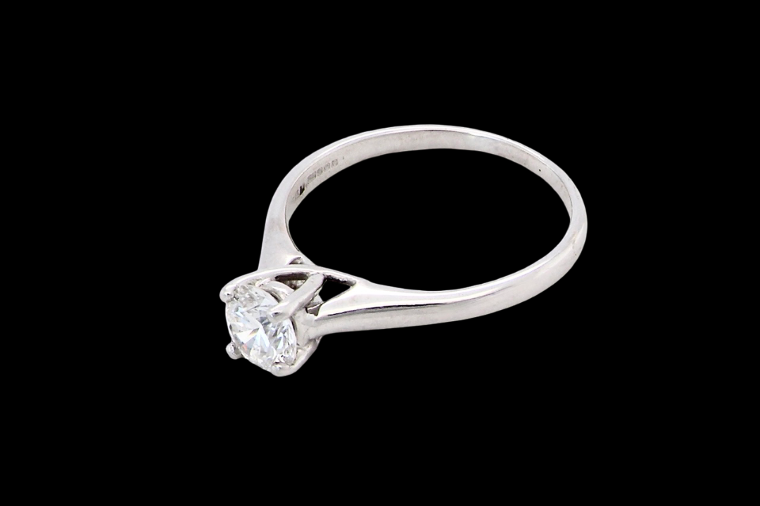 side solitaire ring containing a fine modern brilliant cut white diamond. Measures 5.4mm (.53 carats)
Colour G-h, clarity Si. Modern feature under setting, depth 6.8mm, weight 2.6grams.
