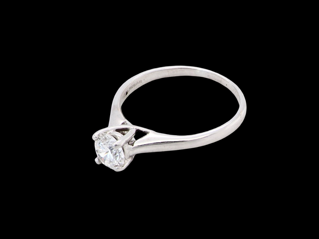 side solitaire ring containing a fine modern brilliant cut white diamond. Measures 5.4mm (.53 carats)
Colour G-h, clarity Si. Modern feature under setting, depth 6.8mm, weight 2.6grams.