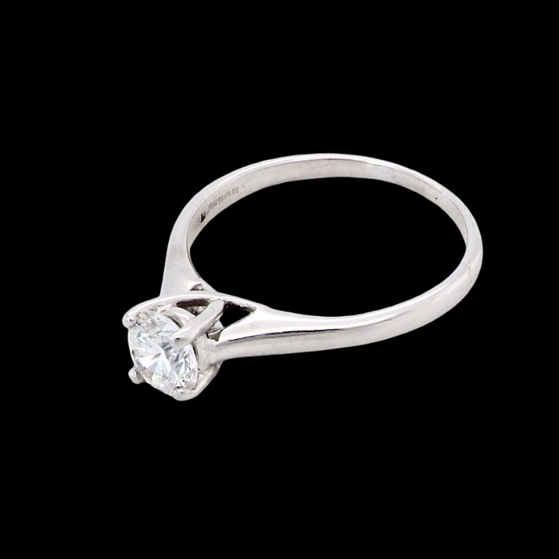 side solitaire ring containing a fine modern brilliant cut white diamond. Measures 5.4mm (.53 carats)
Colour G-h, clarity Si. Modern feature under setting, depth 6.8mm, weight 2.6grams.