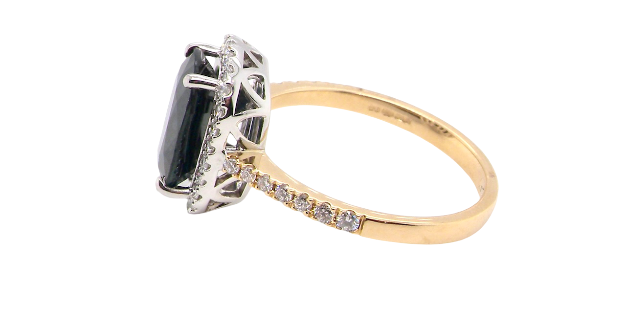 side striking cluster ring featuring a captivating ink-black blue sapphire,