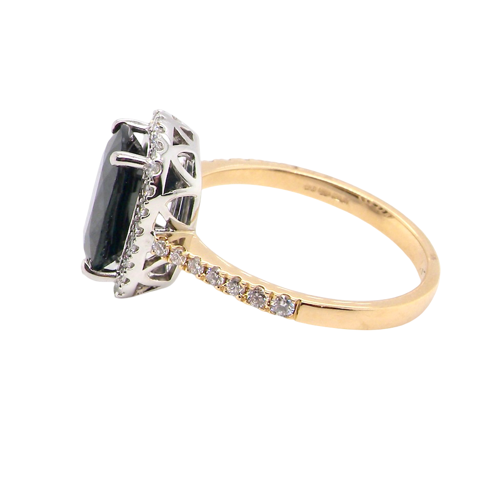 side striking cluster ring featuring a captivating ink-black blue sapphire,