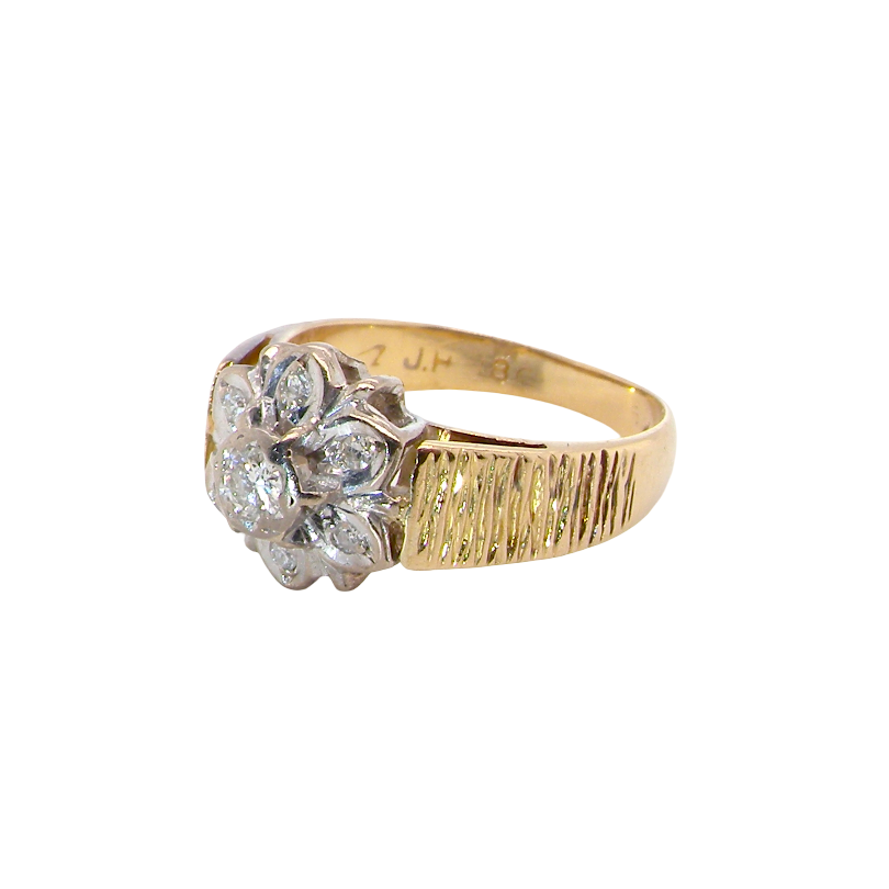 typical design from the 1960s/1970s era, a daisy cluster set with brilliant cut white diamonds