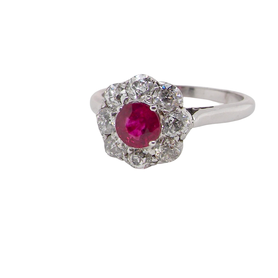 side view A beautiful cluster ring set with a raspberry-red ruby centre stone measuring 5mm in diameter, estimated at approximately 0.50 carats.