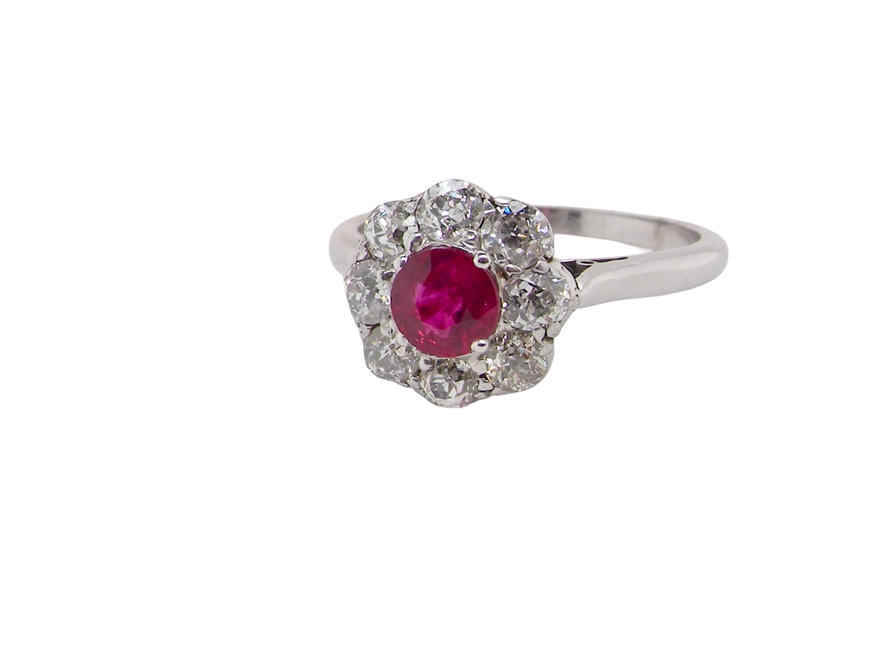 side view A beautiful cluster ring set with a raspberry-red ruby centre stone measuring 5mm in diameter, estimated at approximately 0.50 carats.