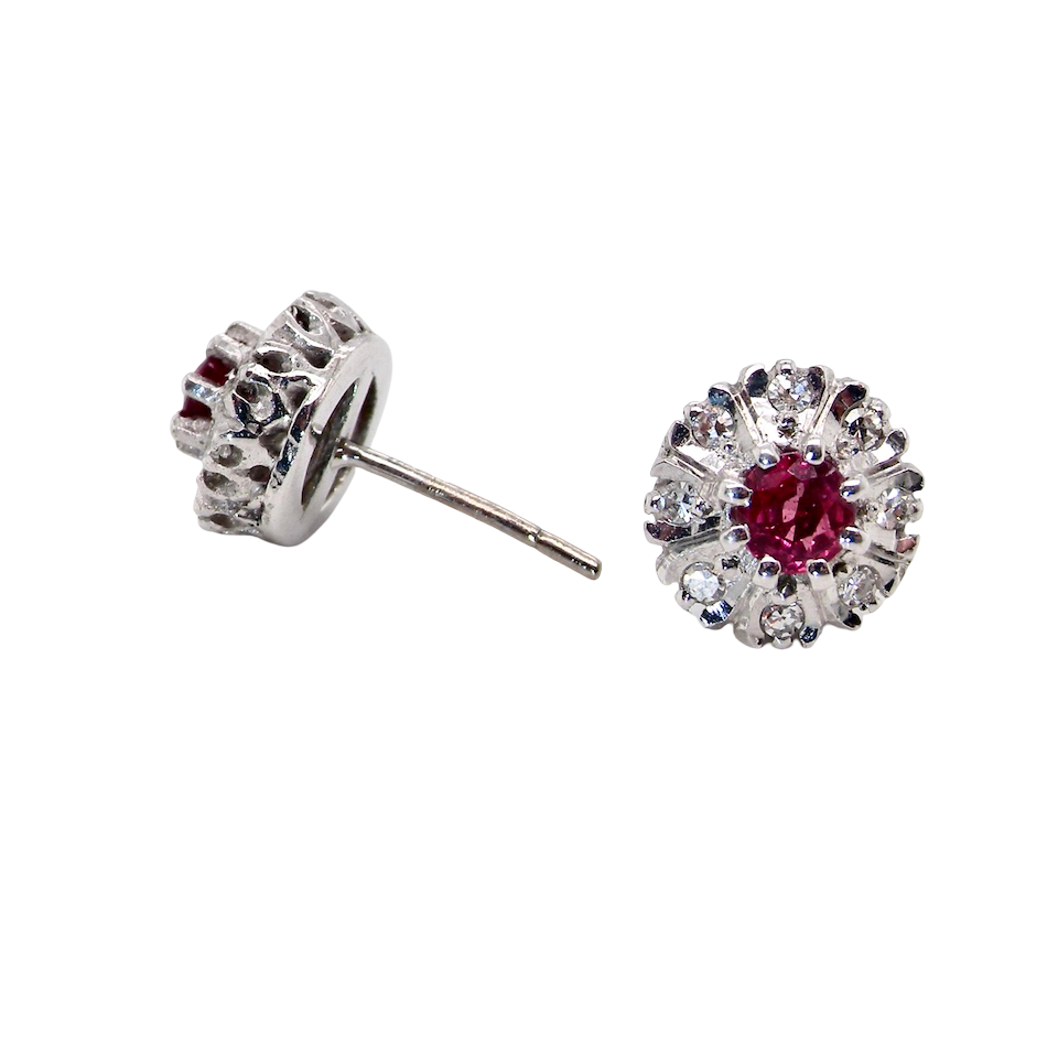 side view A fine pair of cluster earrings. Features to the centre a round 4.6mm pink sapphire (est 0.38 carats) with a good deep colour hue.