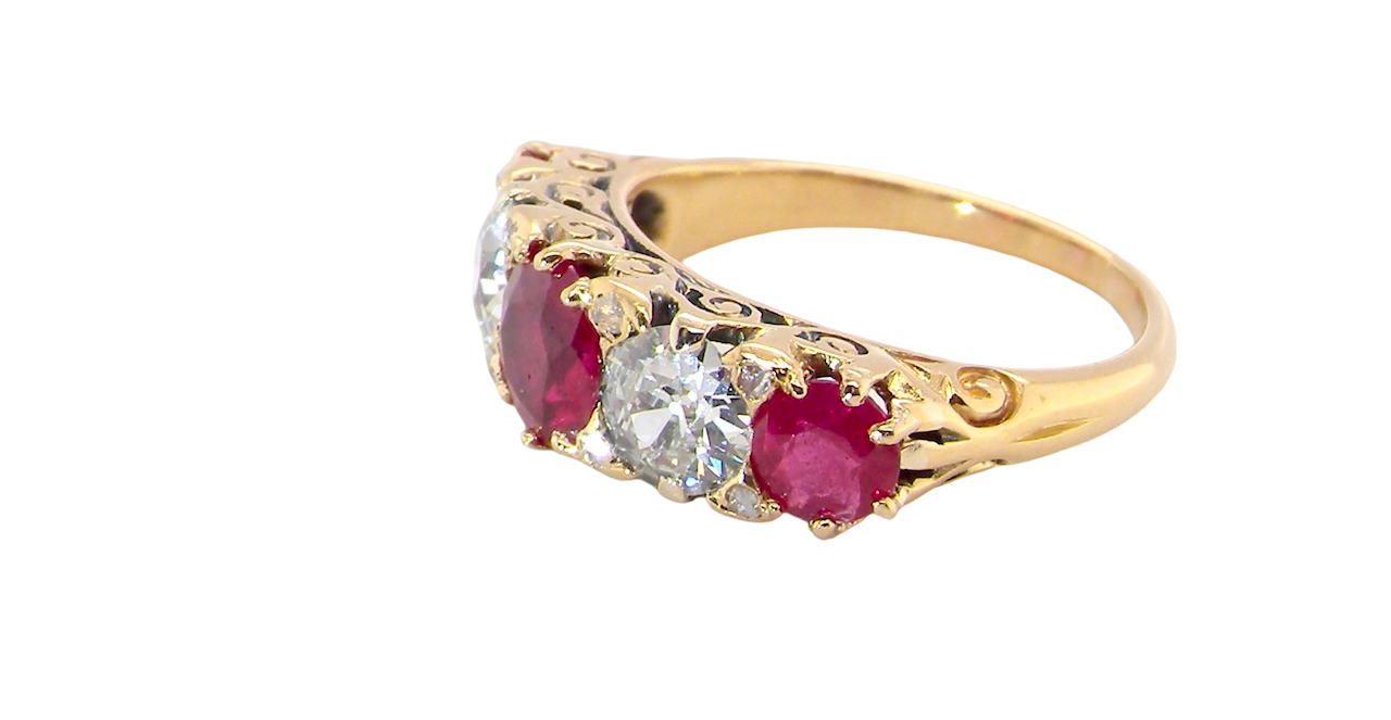 side view A superb Victorian ring, carved boat shaped head. Set with three fine rubies ,