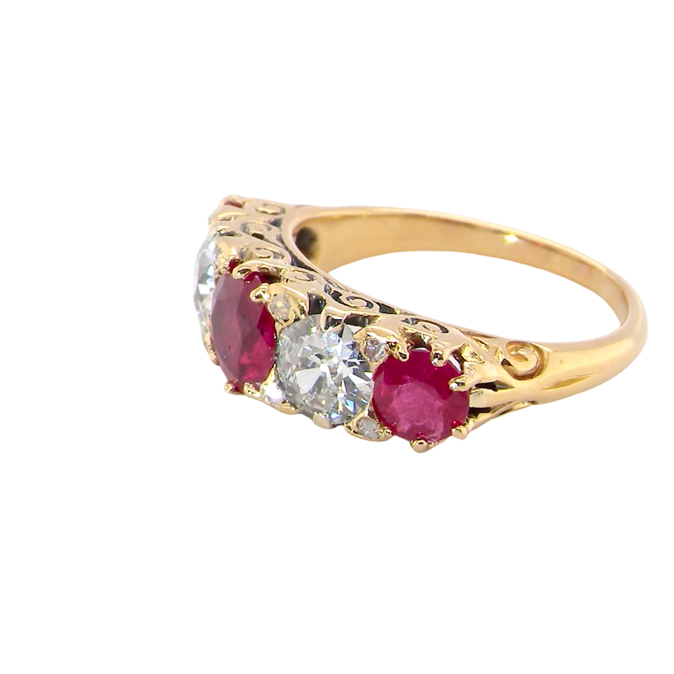 side view A superb Victorian ring, carved boat shaped head. Set with three fine rubies ,