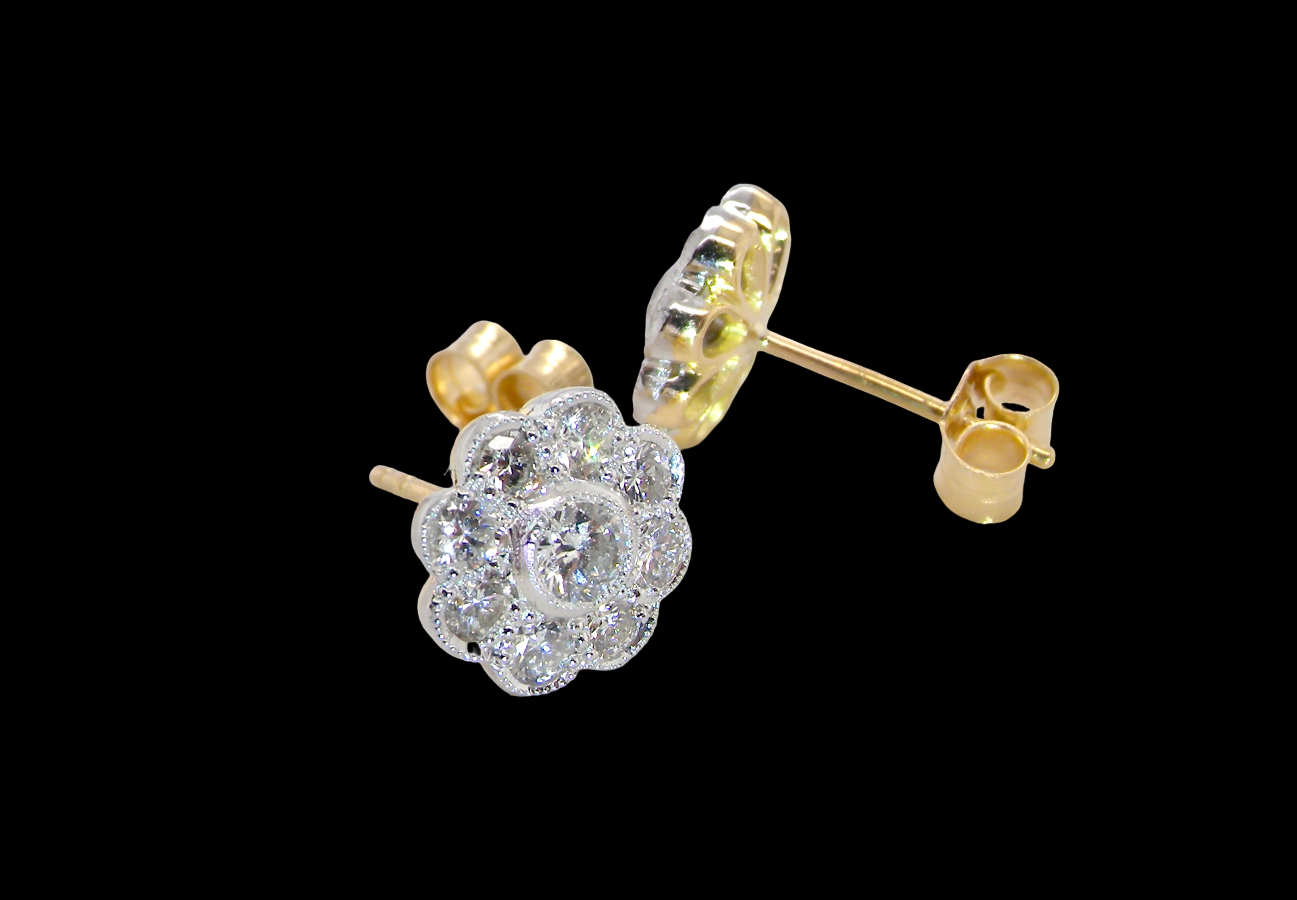side view elegant pair of 18 carat gold* cluster earrings, each beautifully set with brilliant-cut white diamonds.