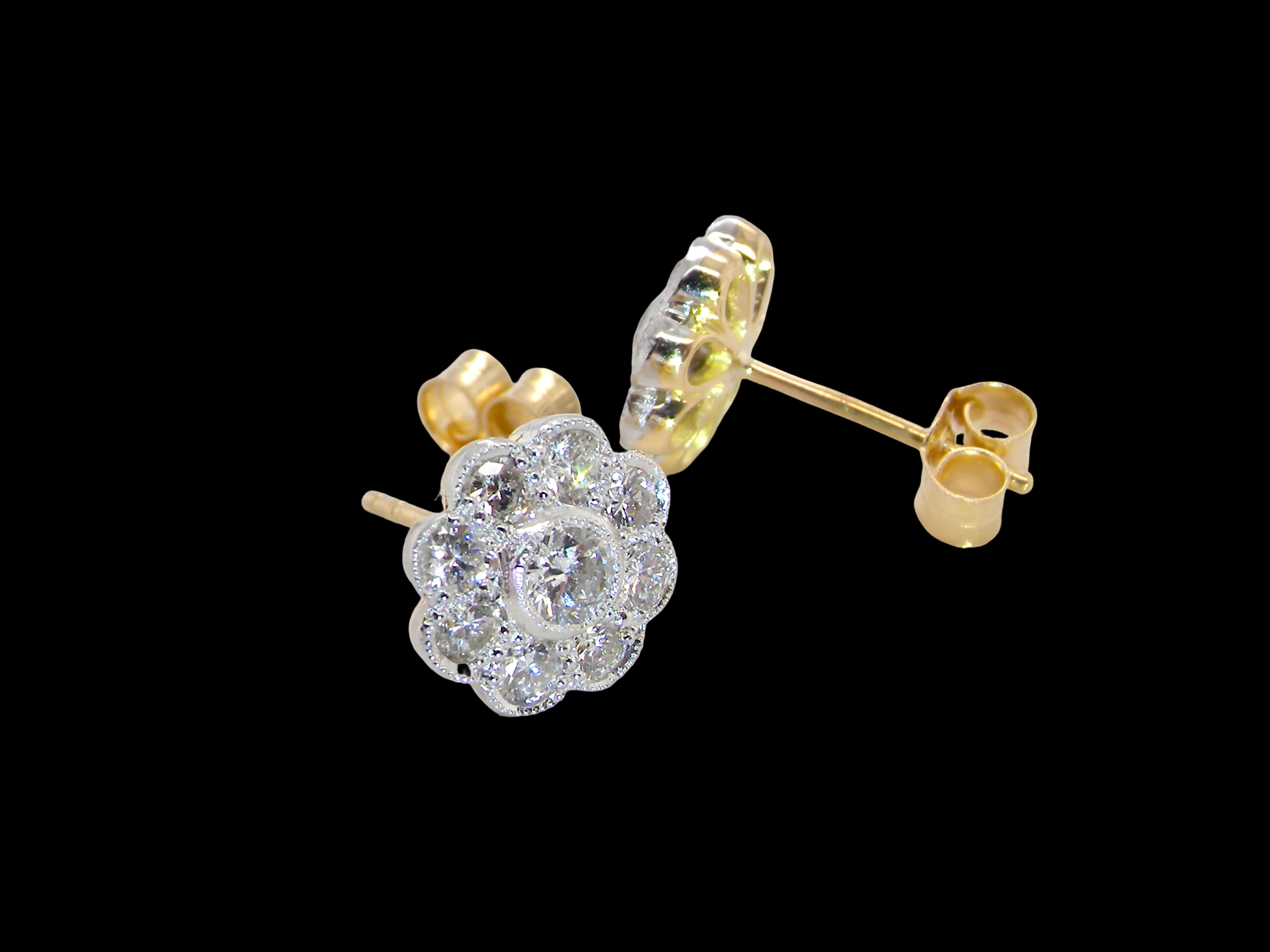 side view elegant pair of 18 carat gold* cluster earrings, each beautifully set with brilliant-cut white diamonds.