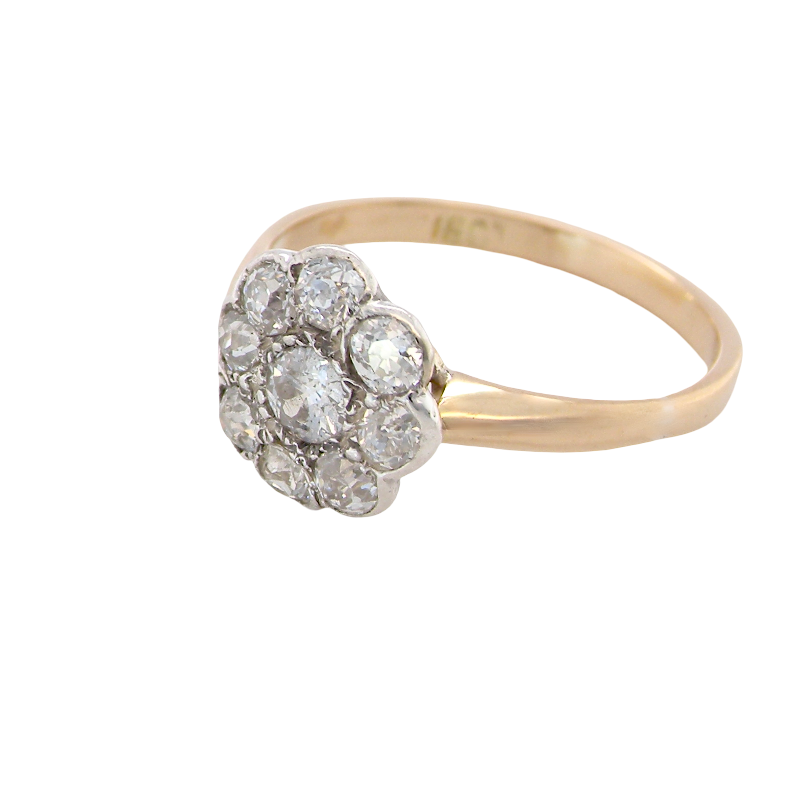 side A vintage cluster ring set with nine old brilliant cut white diamonds. Centre stone 3.7mm (est 0.18 carats) surorunded by eight 2.8mm diamonds (0.08 carats est).