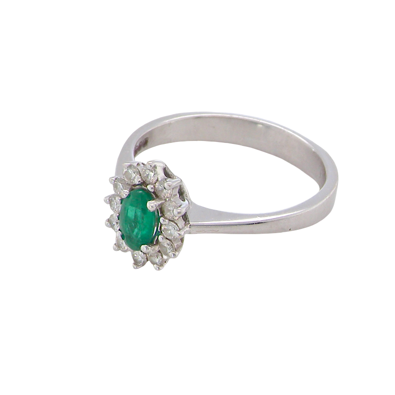 side white gold cluster ring.
Centre stone is an oval cut emerald, 6x3.7mm (just under 0.50 carats) good deep green hue.