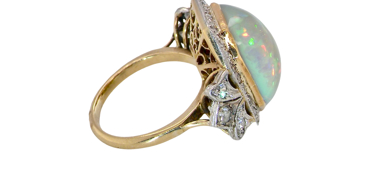 side cabouchon cut opal shown is cushion shaped, measures 15x13 (5.78 carats) displaying a mass of vibrant colours, from flashes of fireglow orange, luminous greens, and lavender purples.