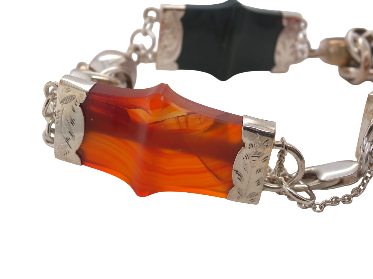 silver bracelet of Scottish origin, featuring a panel of bold, shaped links. Each panel link measures approximately 35 × 20 mm.