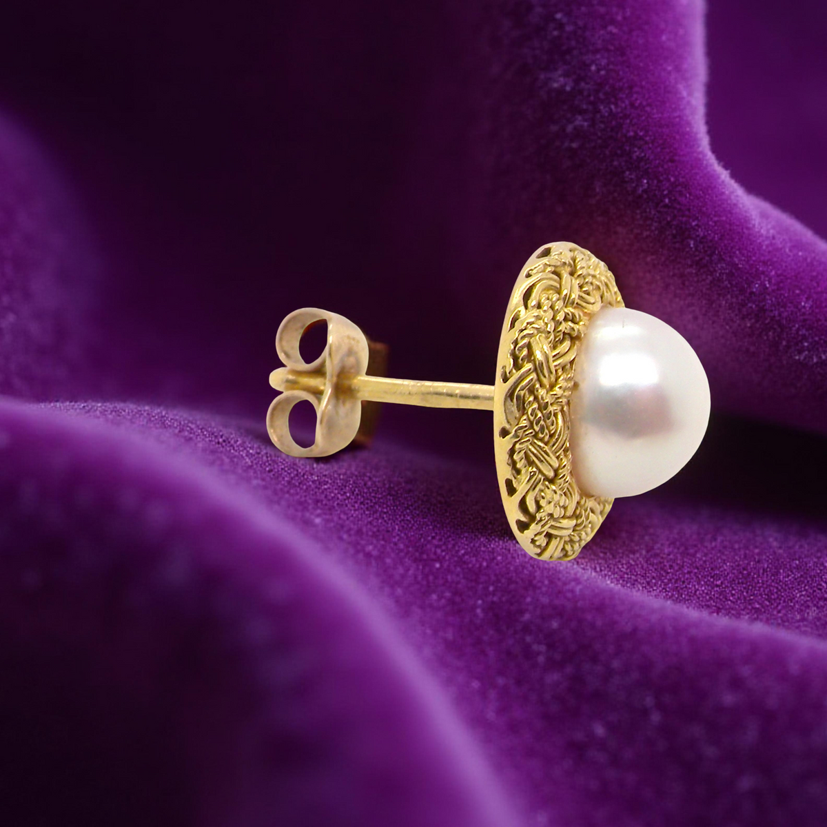 single A lovely pair of elegant earrings, each set with a 7.7 mm cultured pearl.