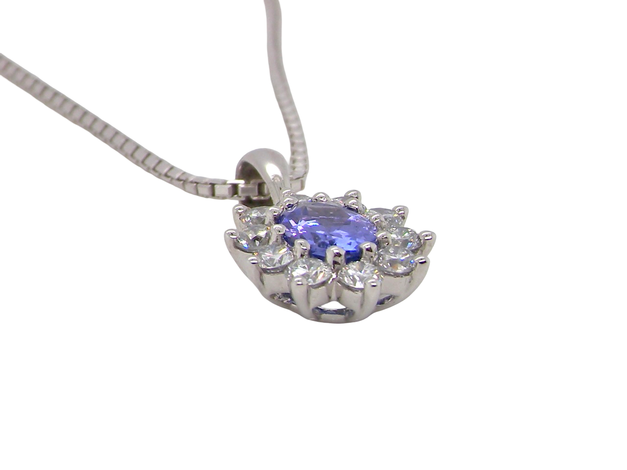 side 18 carat white gold pendant featuring a captivating oval tanzanite