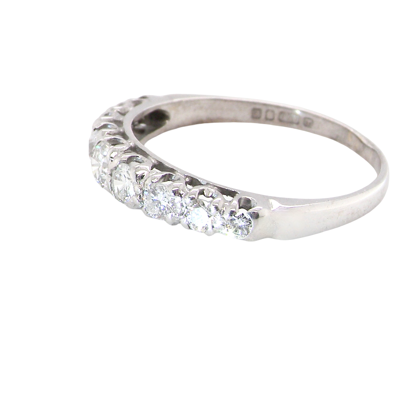A ring with a row of round-cut diamonds set along the front half of a polished band, shown on a plain white background.