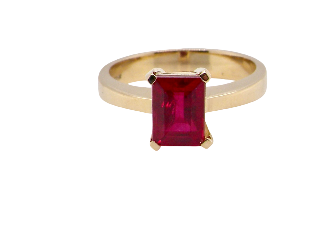 solitaire ring set with a rectangular cut red spinel stone. Measures 8x6mm.