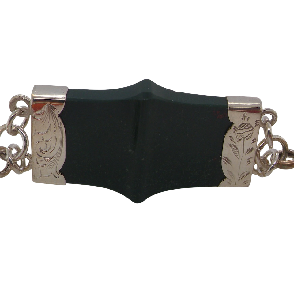 sterling silver bracelet of Scottish origin, featuring a panel of bold, shaped links. Each panel link