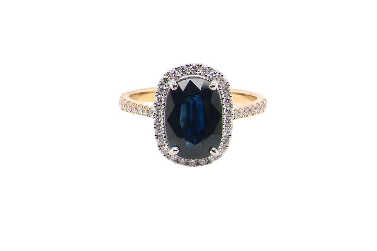 striking cluster ring featuring a captivating ink-black blue sapphire,