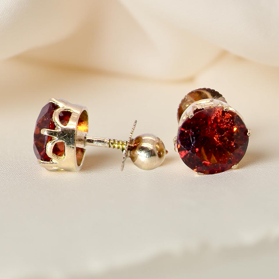 stud earrings. Each one is set with a round garnet, 8mm diameter showing the post