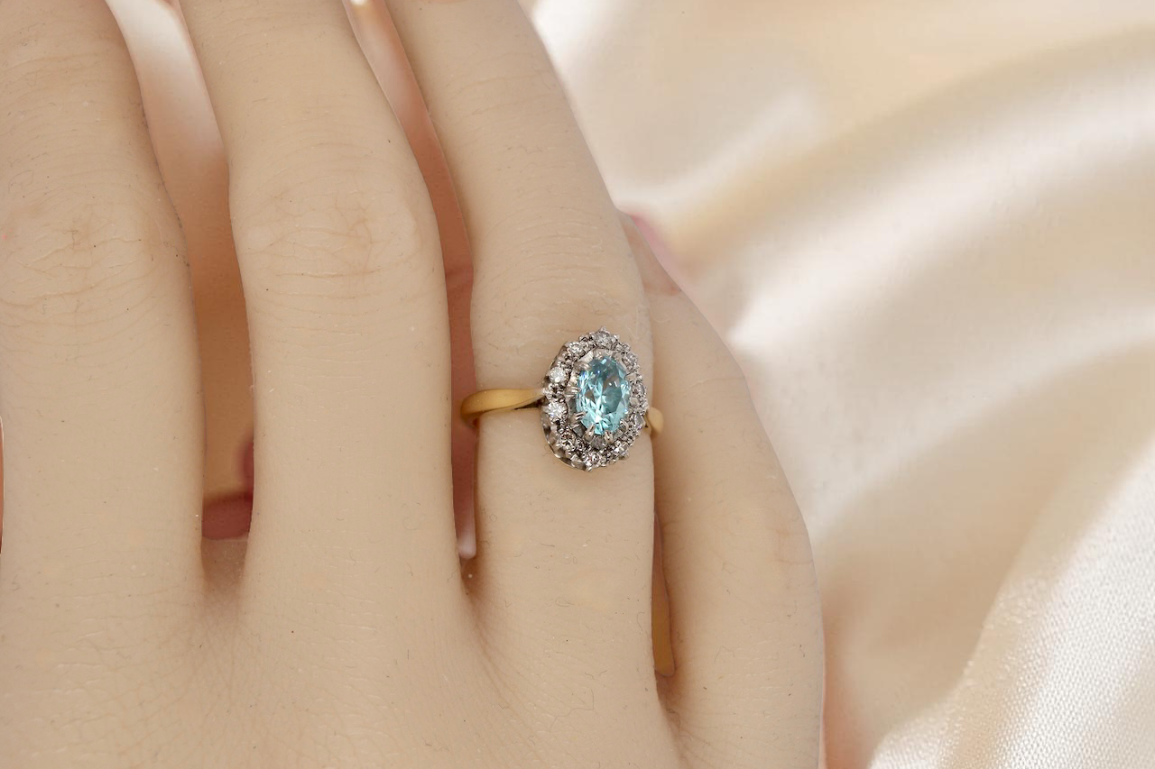 tape A cluster ring set with a natural blue zircon centre stone, 7.5x5mm, vibrant aquamarine colour. 