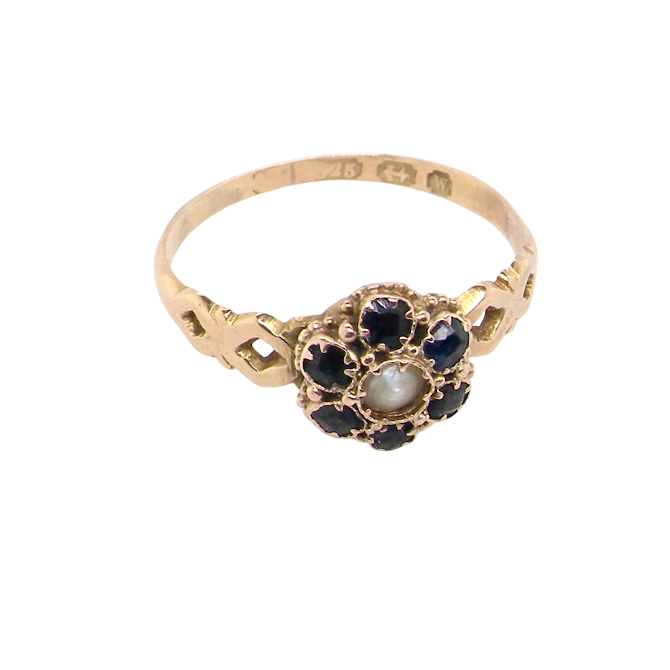 top A 15 carat gold dress ring. The centre a small seed pearl, 3mm diameter. Surrounded by six sapphires,