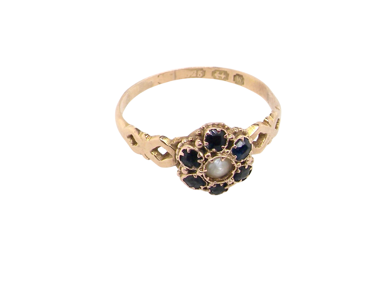 top A 15 carat gold dress ring. The centre a small seed pearl, 3mm diameter. Surrounded by six sapphires,