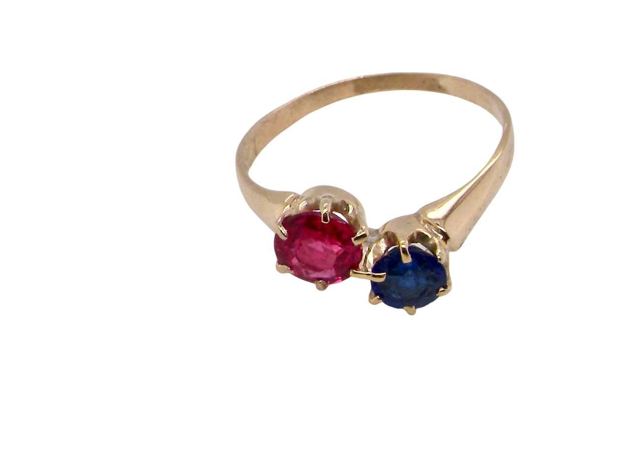 Gold ring with a red and blue gemstone on a white background