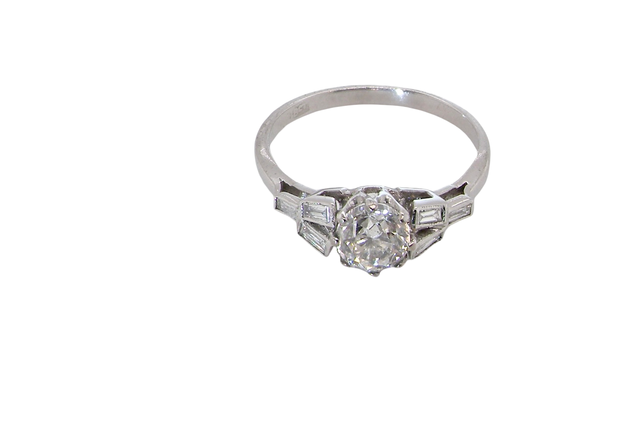 A beautifully proportioned Art Deco solitaire ring showcasing a sparkling old brilliant cut white diamond