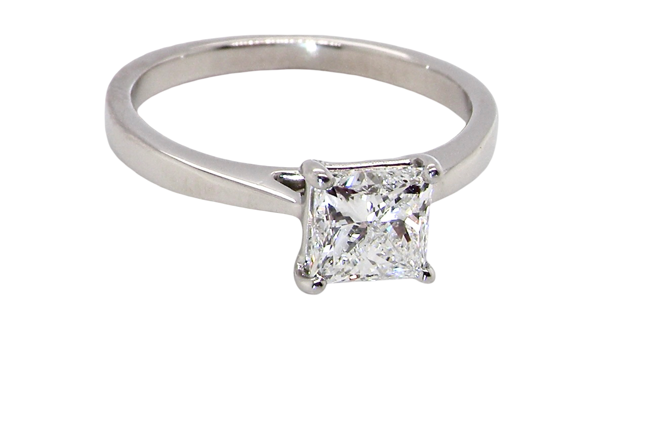 top A fine solitaire ring featuring a square cut diamond of excellent quality.
Superb colour grade of E, excellent clarity- graded VVS2*. Stone measures 5x5x3.68, confirmed as 0.83 carats.