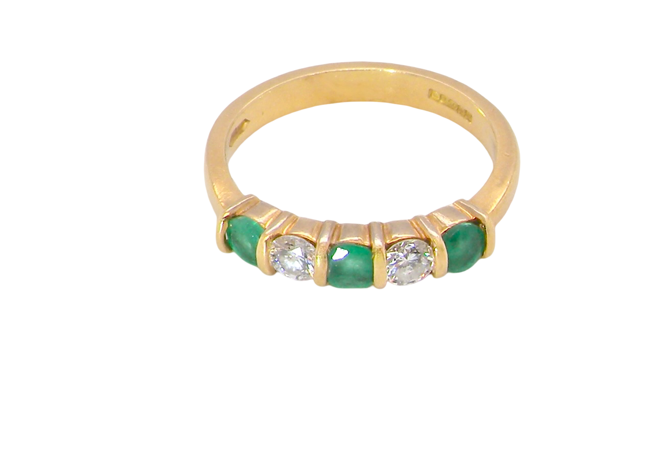 top A five stone ring set with three emeralds, each 3mm diameter.
Between each two brilliant cut white diamonds, each 3.4mm (0.15 carats each est), colour i-j, clarity Si.