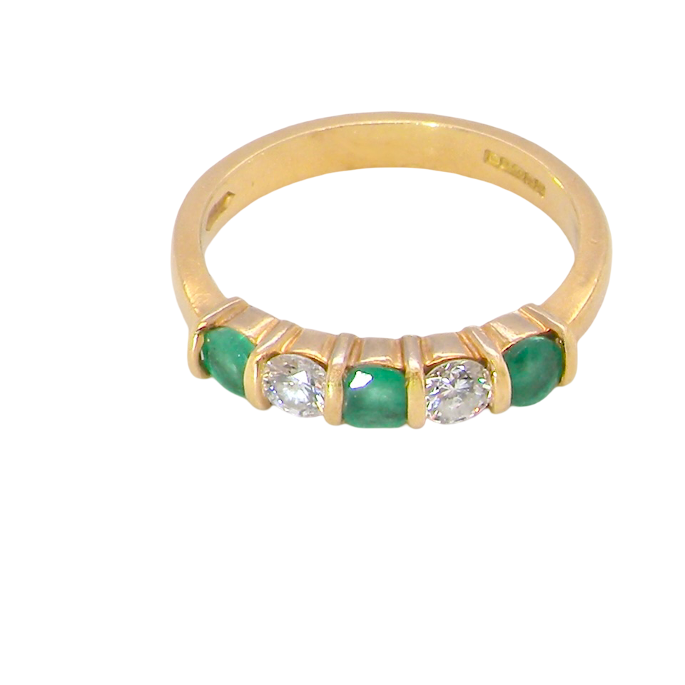 top A five stone ring set with three emeralds, each 3mm diameter.
Between each two brilliant cut white diamonds, each 3.4mm (0.15 carats each est), colour i-j, clarity Si.