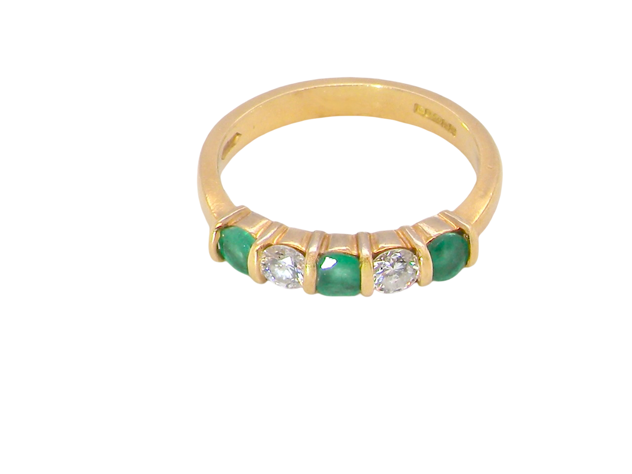 top A five stone ring set with three emeralds, each 3mm diameter.
Between each two brilliant cut white diamonds, each 3.4mm (0.15 carats each est), colour i-j, clarity Si.