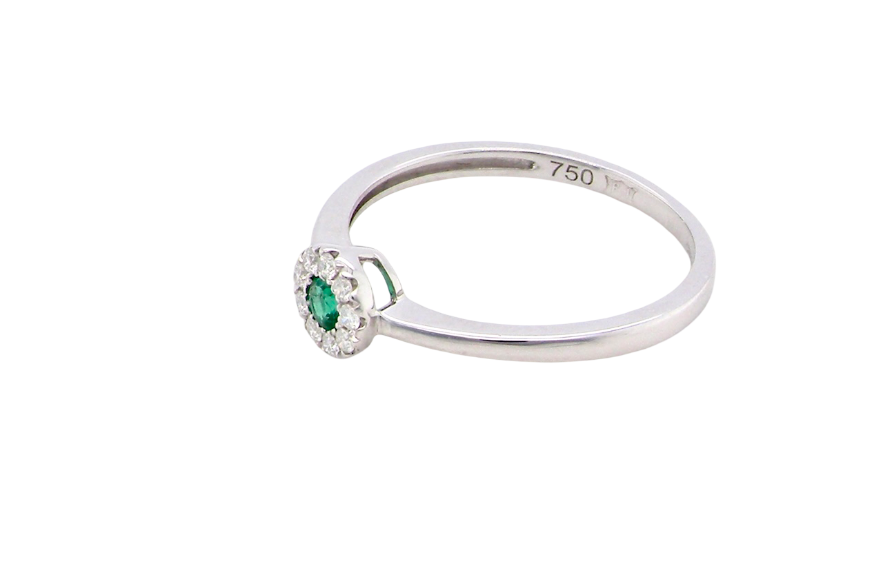 top A mini cluster fashioned in 18 carat white gold. The round emerald measures 2.7mm (0.05 carats) 