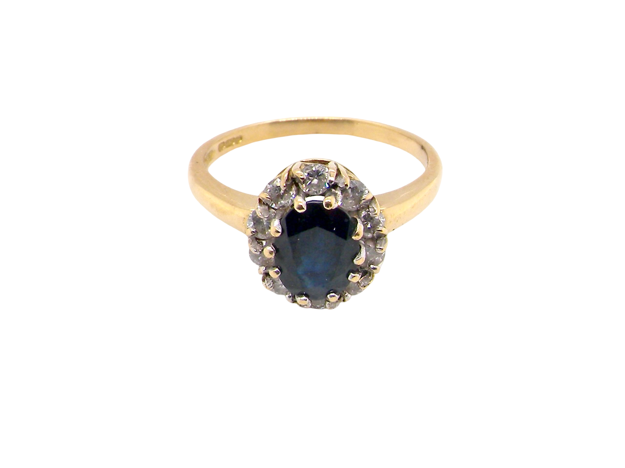 top An elegant 18 carat gold cluster ring featuring a striking inky dark blue sapphire at its centre.