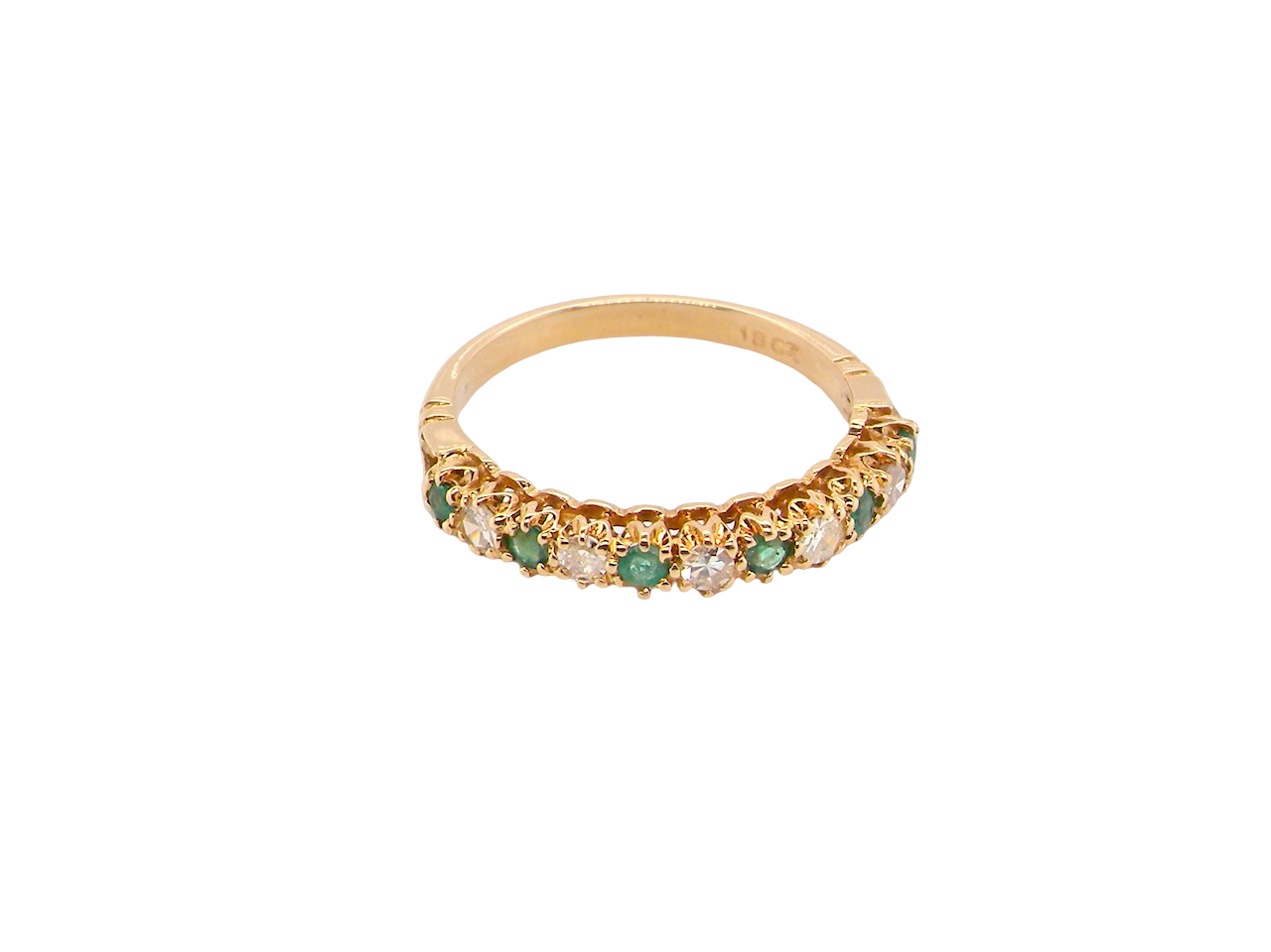 top half-eternity ring set with alternating emeralds and diamonds.