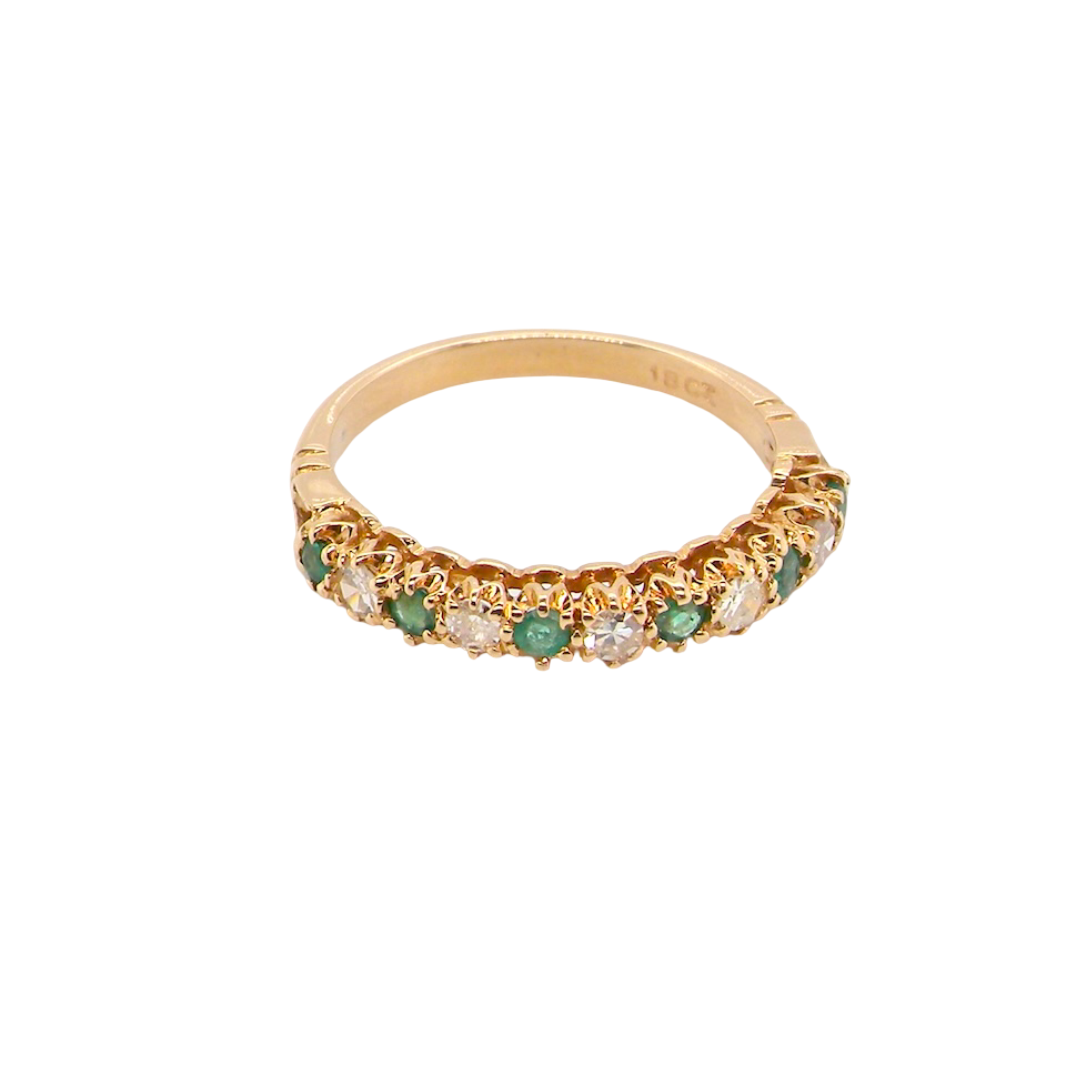 top half-eternity ring set with alternating emeralds and diamonds.