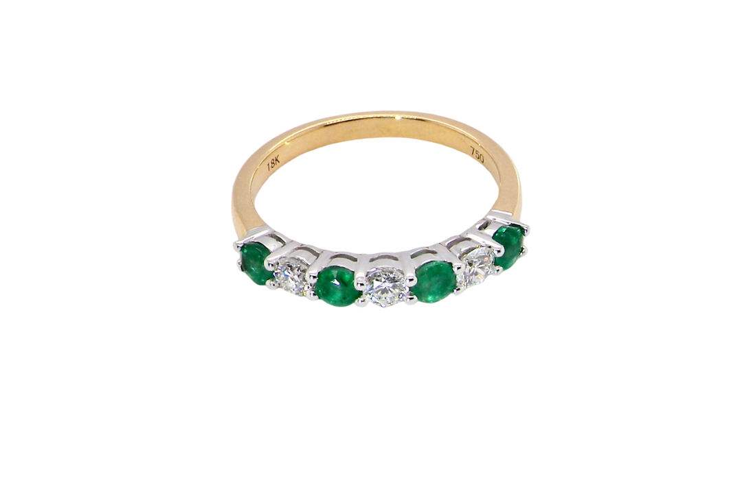 top view A NEW seven stone half hoop eternity ring. Set with four round emeralds, each 2.8mm (total 0.40 carats)