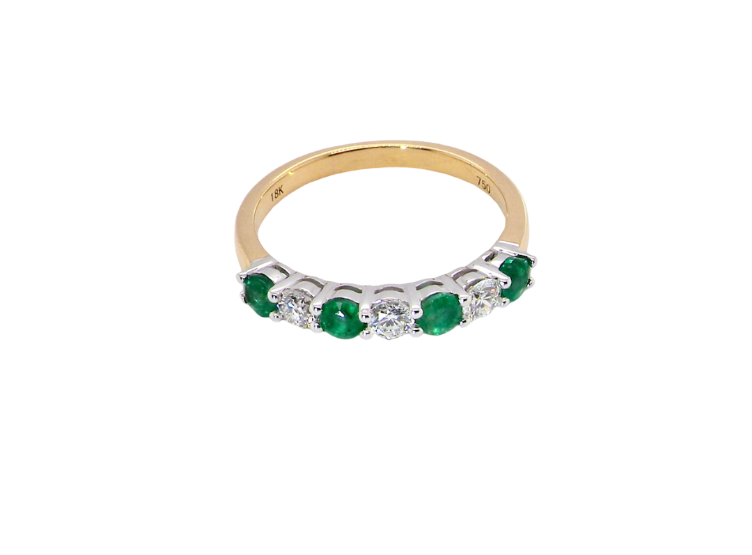 top view A NEW seven stone half hoop eternity ring. Set with four round emeralds, each 2.8mm (total 0.40 carats)