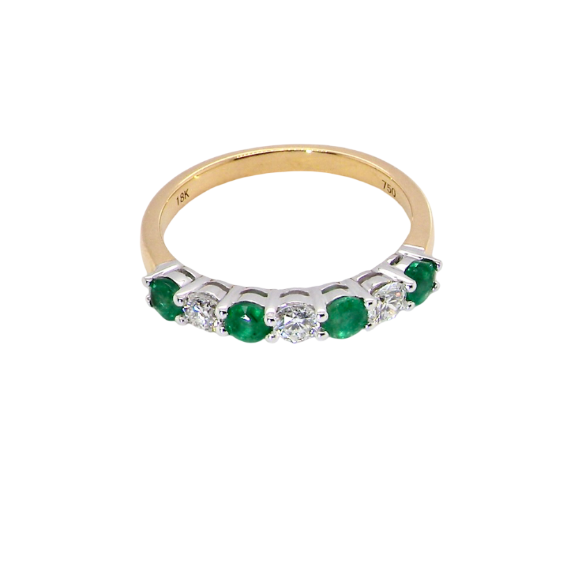 top view A NEW seven stone half hoop eternity ring. Set with four round emeralds, each 2.8mm (total 0.40 carats)