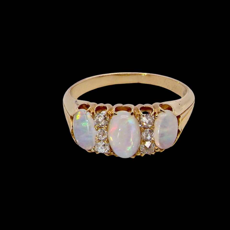 top view A beautiful Victorian dress ring, set with three finely matched oval opals,