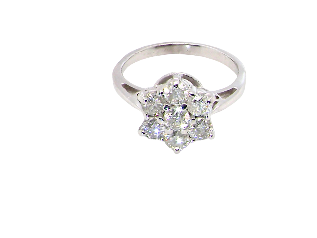 top view A beautiful vintage diamond cluster ring, elegantly set with seven brilliant-cut white diamonds in a timeless floral cluster design.