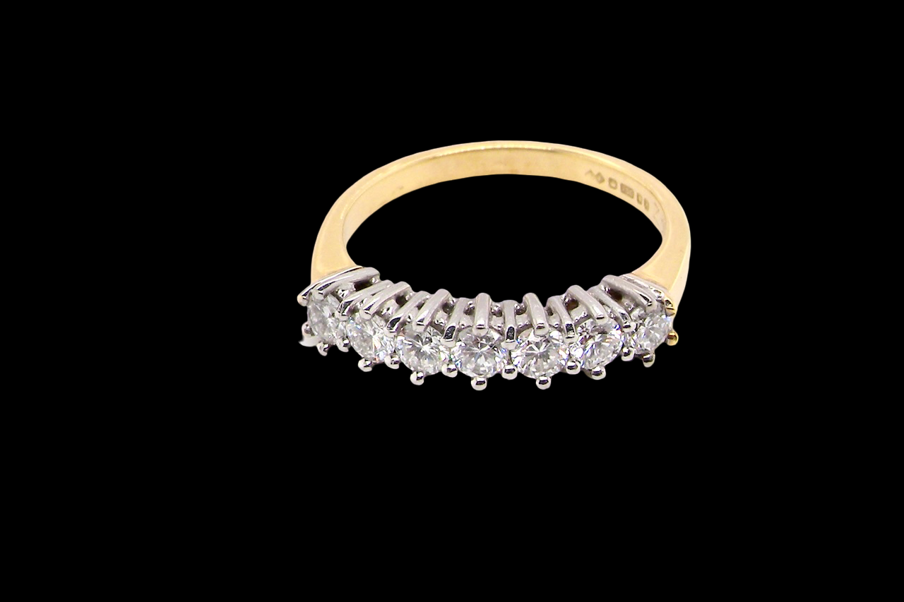 top view A fine 18 carat gold half hoop eternity ring, beautifully set with an array of seven brilliant-cut white diamonds.