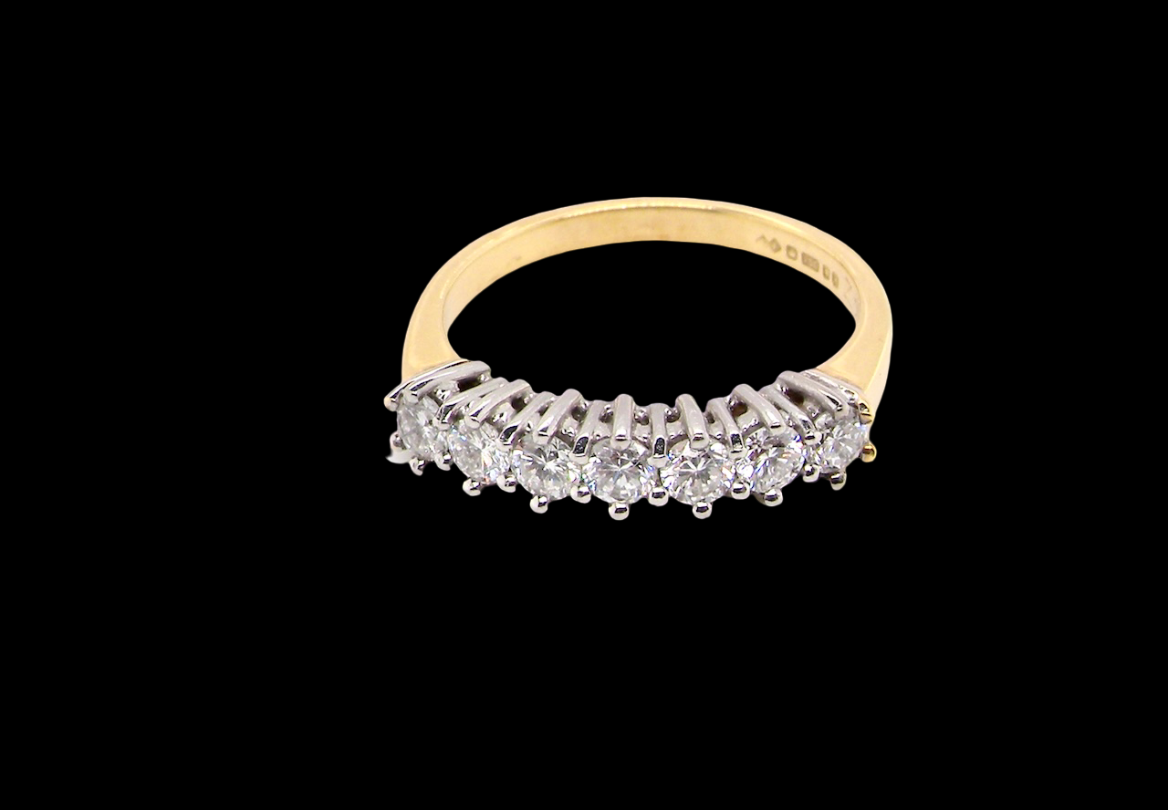 top view A fine 18 carat gold half hoop eternity ring, beautifully set with an array of seven brilliant-cut white diamonds.
