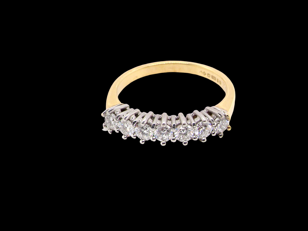top view A fine 18 carat gold half hoop eternity ring, beautifully set with an array of seven brilliant-cut white diamonds.