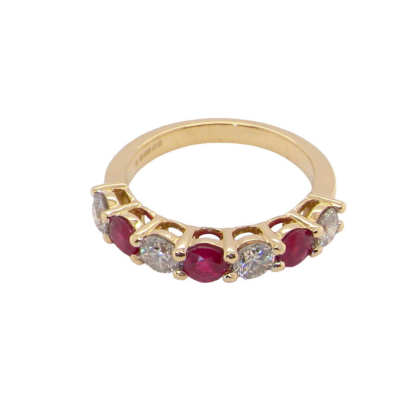top view A fine half hoop ring. 18 carat gold set with three rubies, each 3.8mm (est 0.20 carats, total 0.67 carats) and four brilliant cut white diamonds, each 3.8mm (total 0.85 carats) 