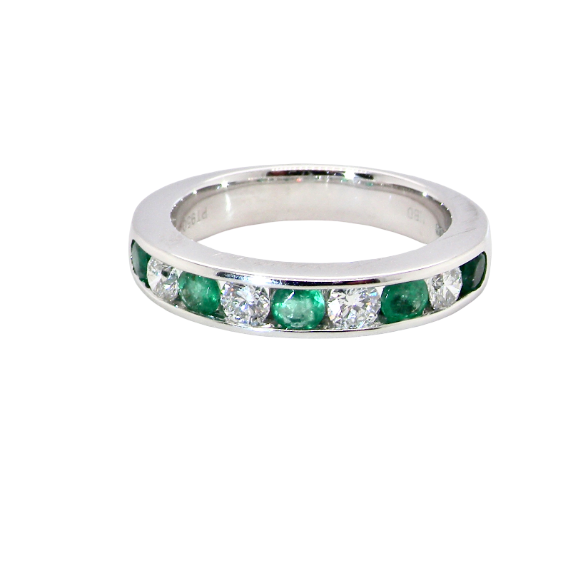 top view A fine platinum half hoop eternity ring. This is a new ring*. Channel set gem stones, five bright green emeralds 2.6mm each (0.54 carats total)
