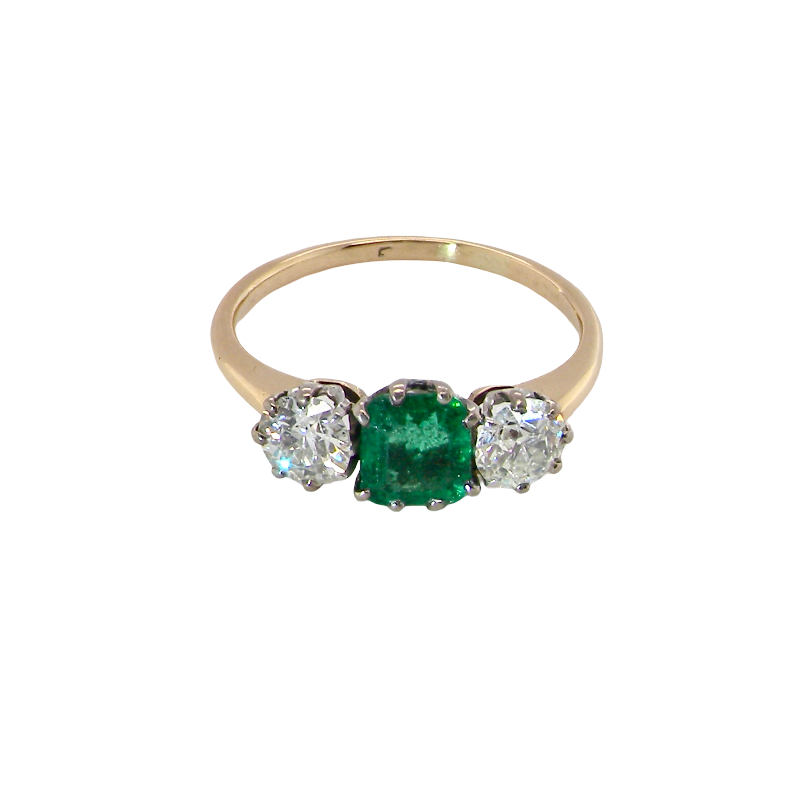 top view A vintage trilogy ring. Centre stone a step cut emerald, 6.5x5.5mm (est .75 carats). The emerald is dark green.