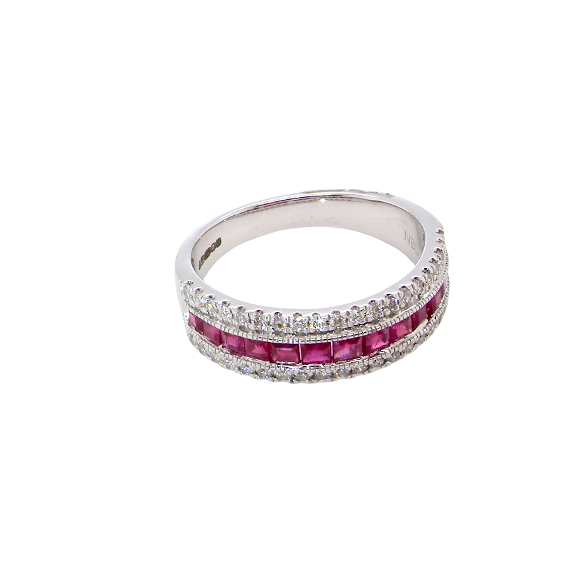 top view An 18 carat white gold half hoop ring. A triple row design with a line of channel set calibre cut rubies running along the centre , to a total carat weight of 0.97 carats.