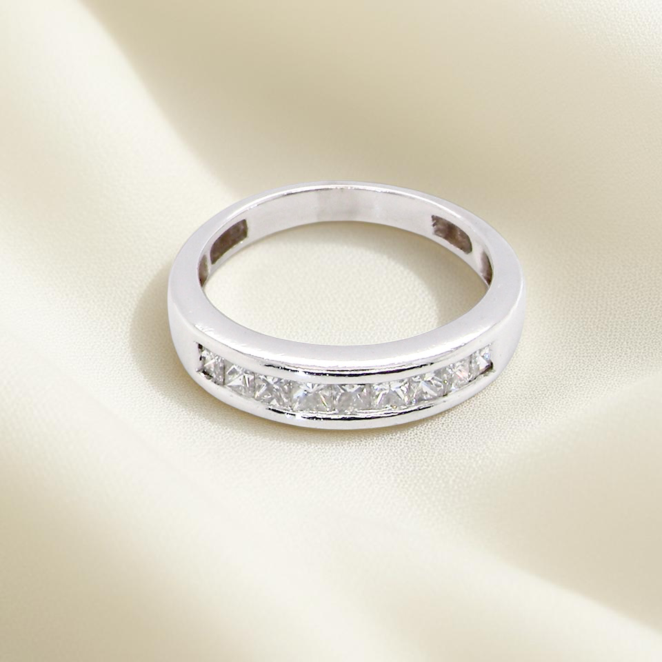 top view An elegant half-hoop eternity ring set with nine princess-cut white diamonds, each measuring approximately 2.5mm, with a total estimated diamond weight of 0.90 carats.